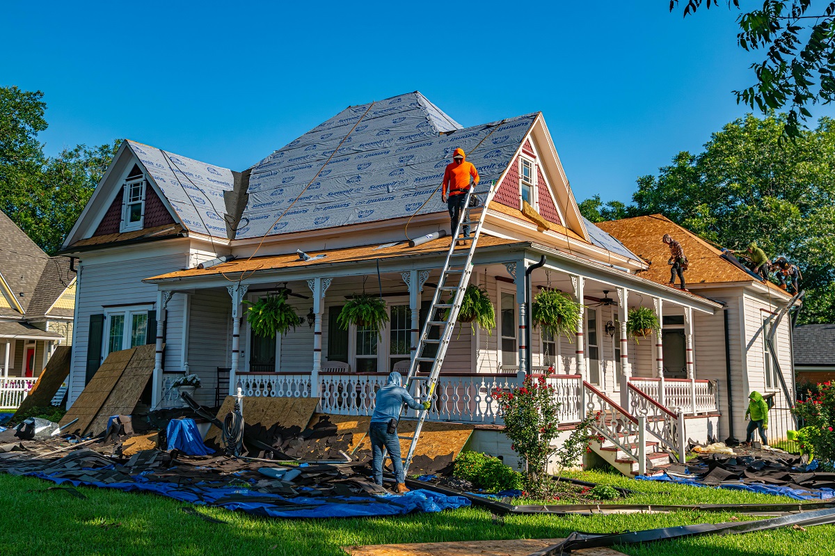 men working on a home's roof
